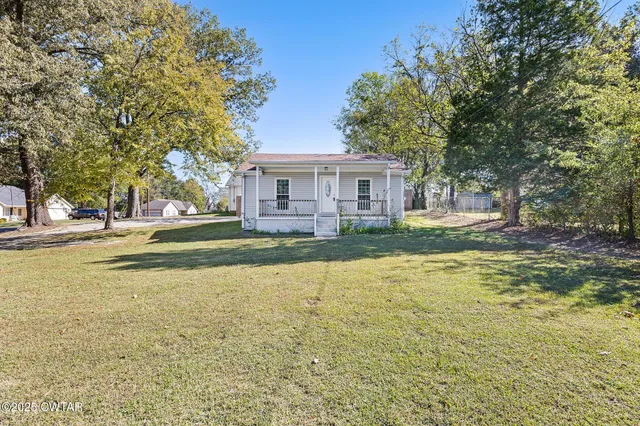 a house view with swimming pool in front of it