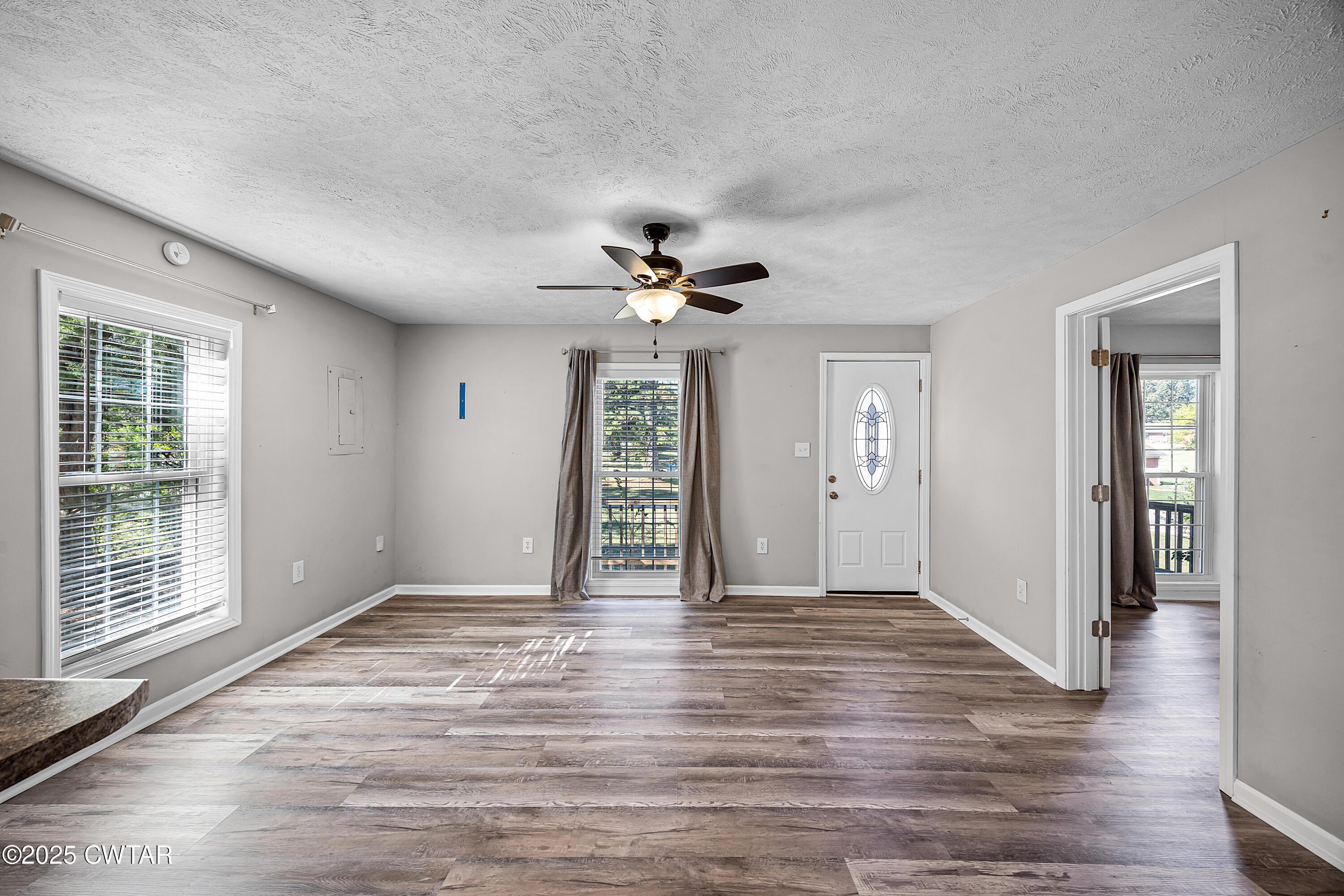 462 Mifflin Avenue Henderson, TN 38340 - Photo 3 of 18 a view of an empty room with wooden floor and a window