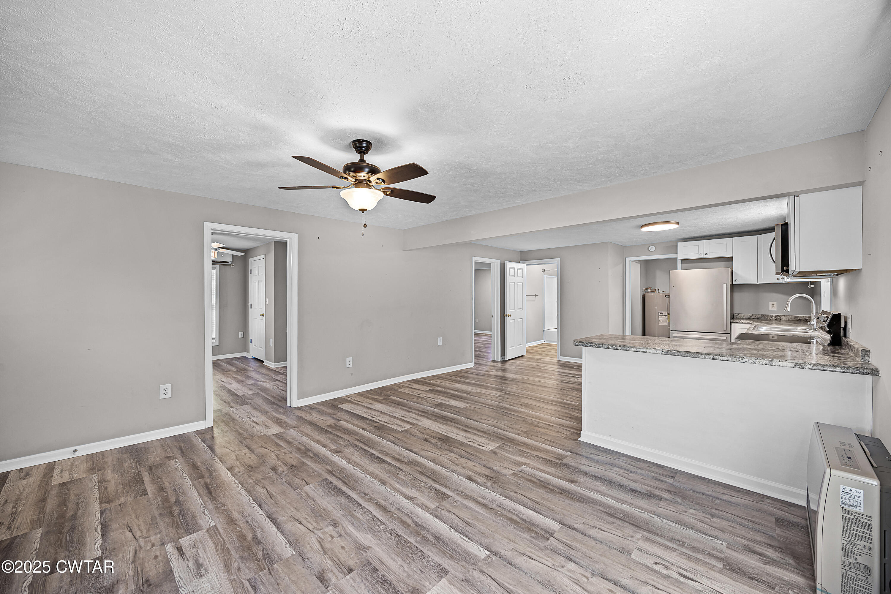 462 Mifflin Avenue Henderson, TN 38340 - Photo 5 of 18 a view of empty room with wooden floor and window