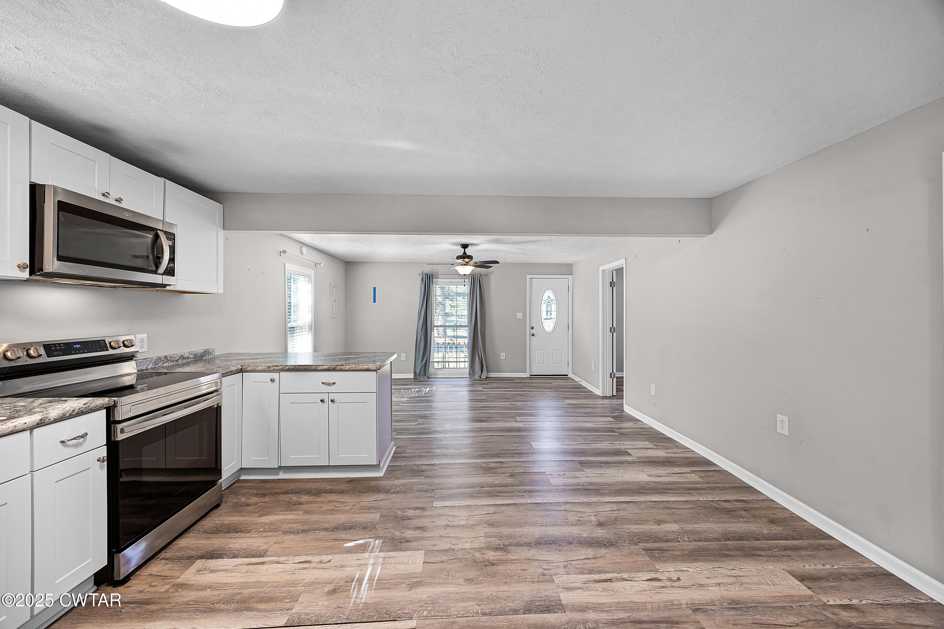 462 Mifflin Avenue Henderson, TN 38340 - Photo 7 of 18 a kitchen with granite countertop a stove top oven and cabinets