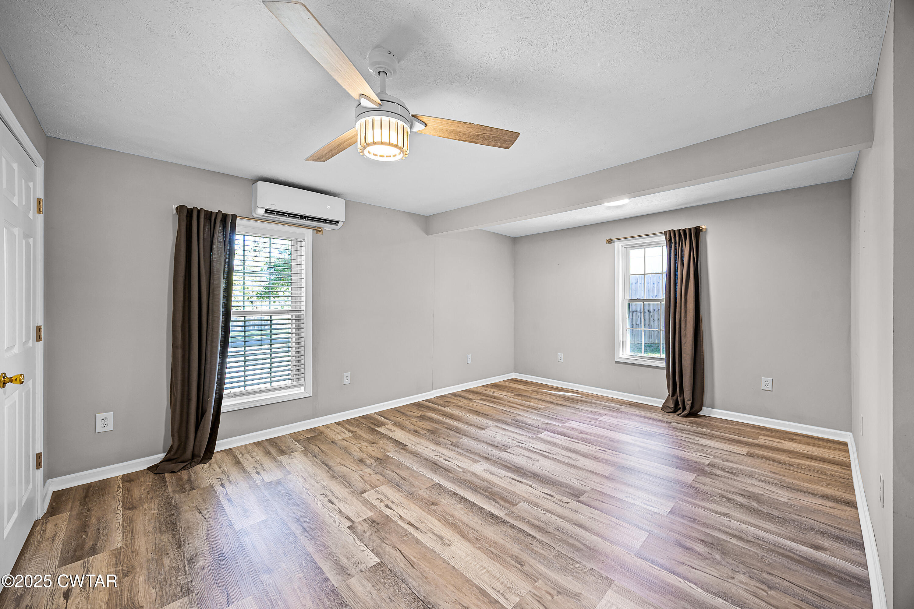 462 Mifflin Avenue Henderson, TN 38340 - Photo 9 of 18 a view of an empty room with wooden floor and a window