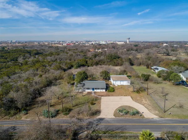 an aerial view of residential houses with outdoor space