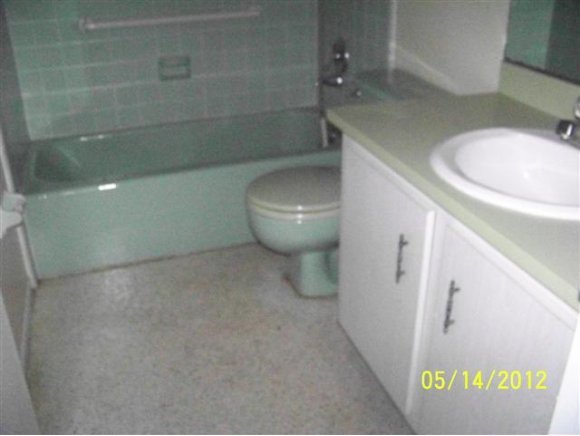 2959 Northeast Gemini Palm Bay, FL 32905 - Photo 5 of 12 a bathroom with a toilet and a sink