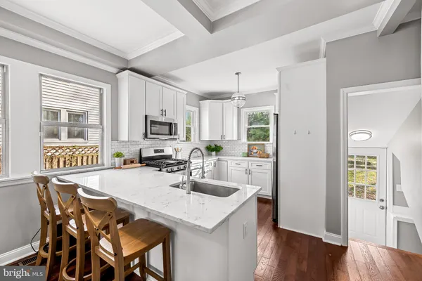 a kitchen with a table chairs refrigerator and microwave