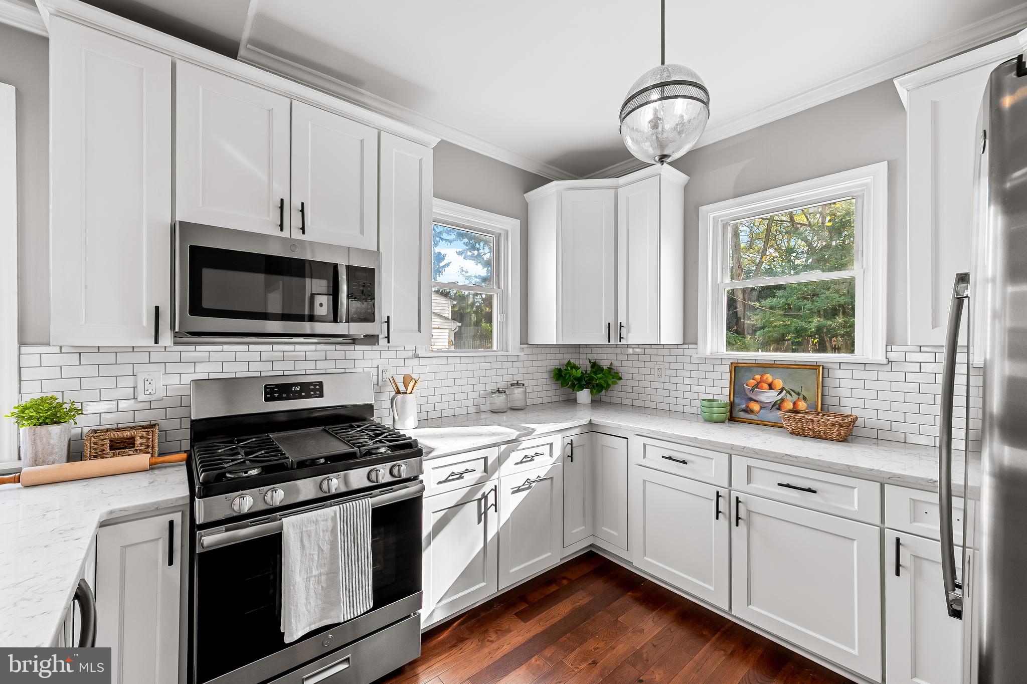 709 Cedarcroft Road Baltimore, MD 21212 - Photo 15 of 38 a kitchen with white cabinets appliances and a window