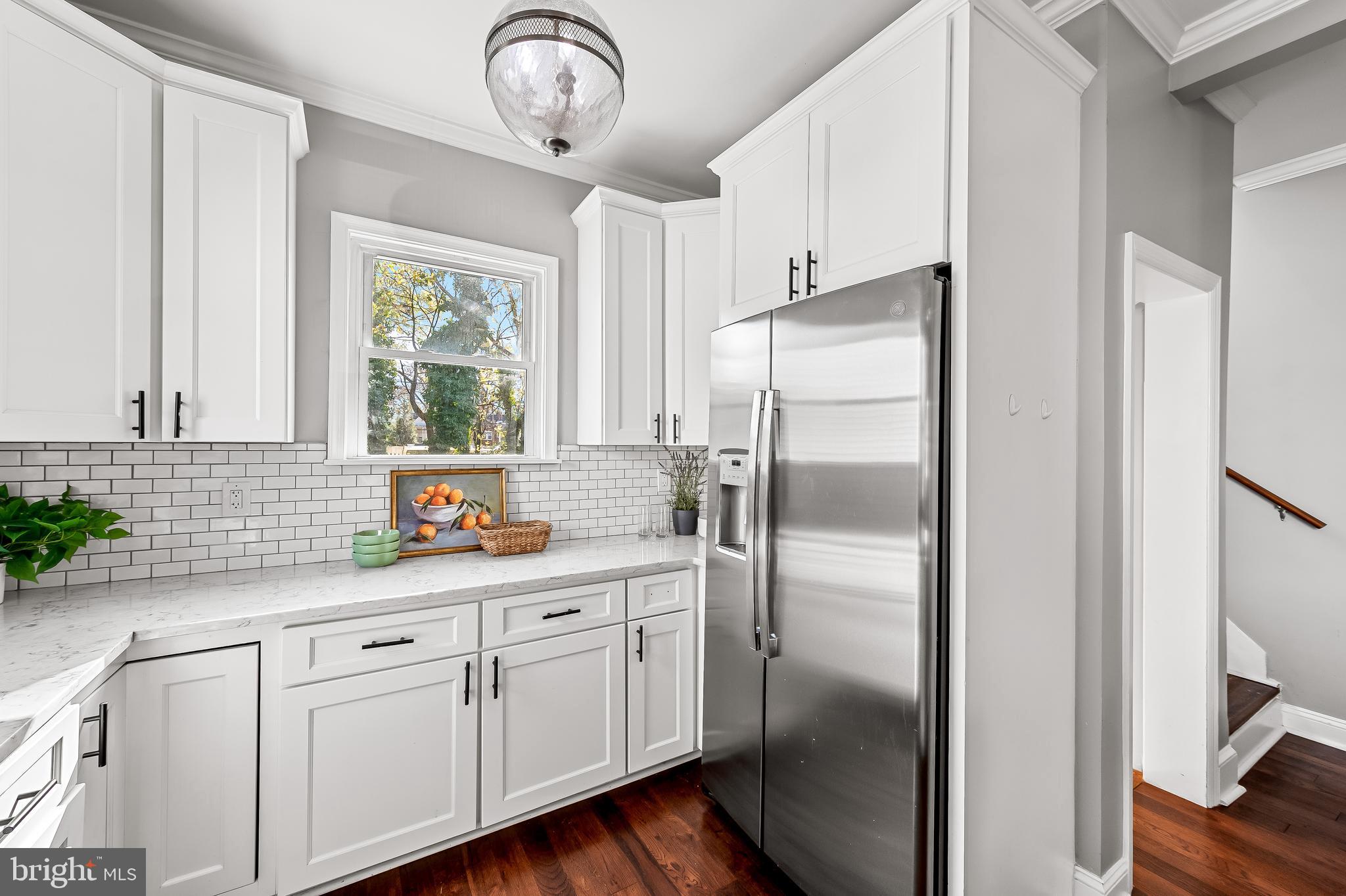 709 Cedarcroft Road Baltimore, MD 21212 - Photo 16 of 38 a kitchen with a refrigerator sink and cabinets
