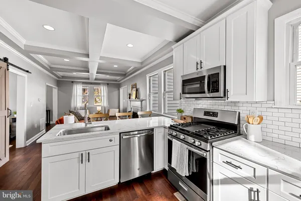 a kitchen with stainless steel appliances stove microwave and cabinets