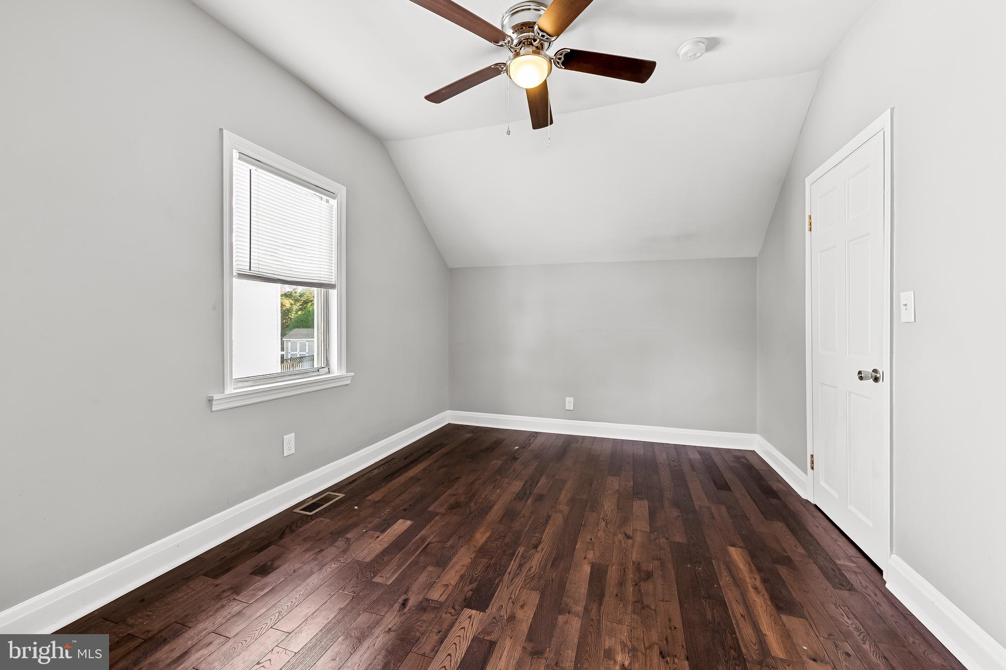 709 Cedarcroft Road Baltimore, MD 21212 - Photo 26 of 38 an empty room with wooden floor fan and windows
