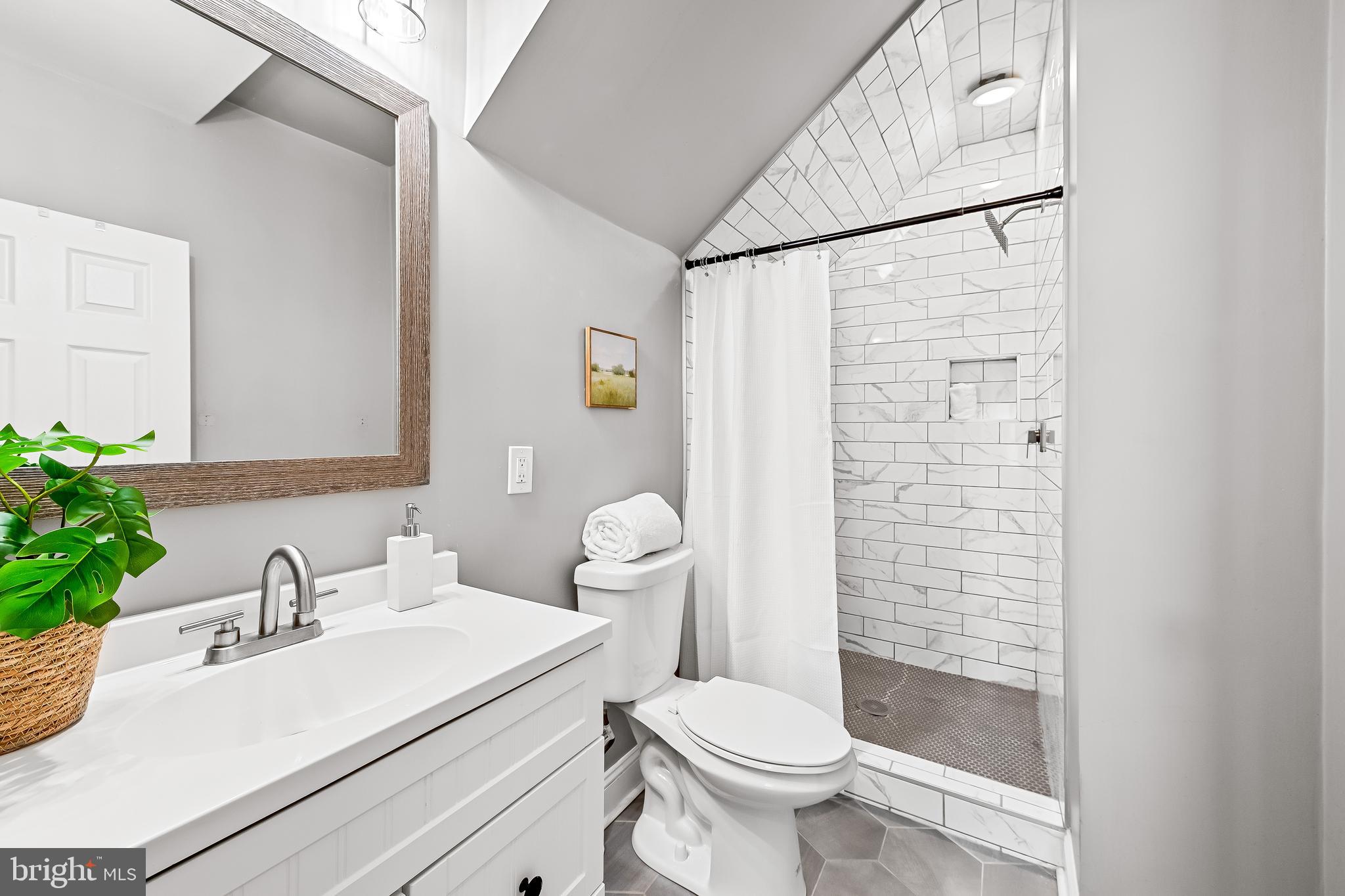 709 Cedarcroft Road Baltimore, MD 21212 - Photo 27 of 38 a bathroom with a sink a toilet and shower