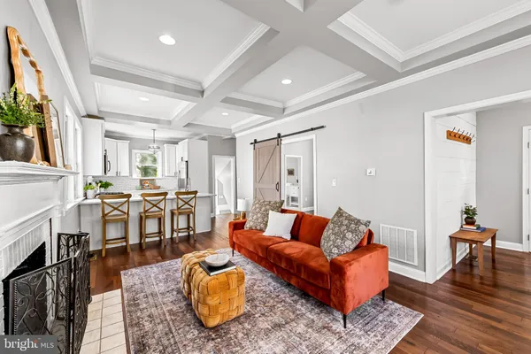 a living room with furniture wooden floor and a fireplace