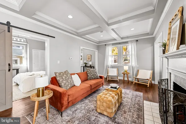 a living room with fireplace furniture and a rug
