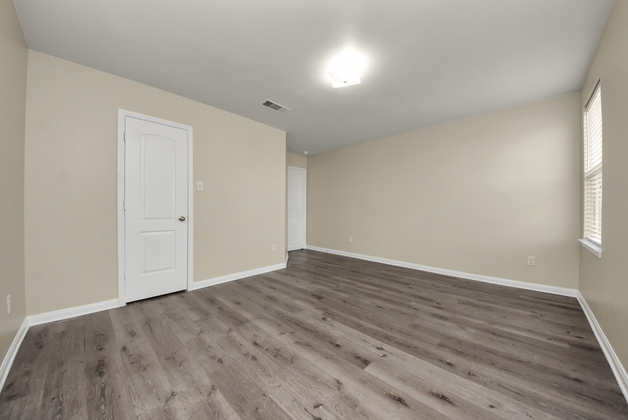 1855 Garnet Breeze Drive Rosharon, TX 77583 - Photo 27 of 40 a view of an empty room with wooden floor and a window
