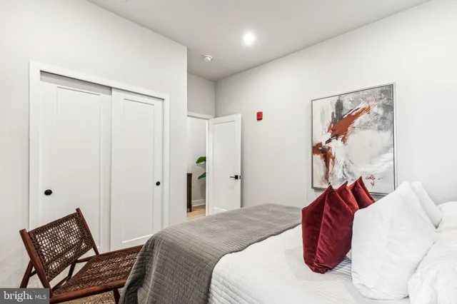 a bedroom with a bed and a painting on the wall