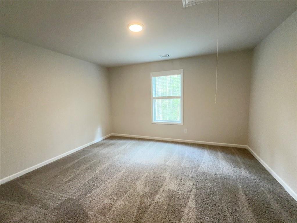345 Rodeo Drive Auburn, GA 30011 - Photo 19 of 22 an empty room with a window