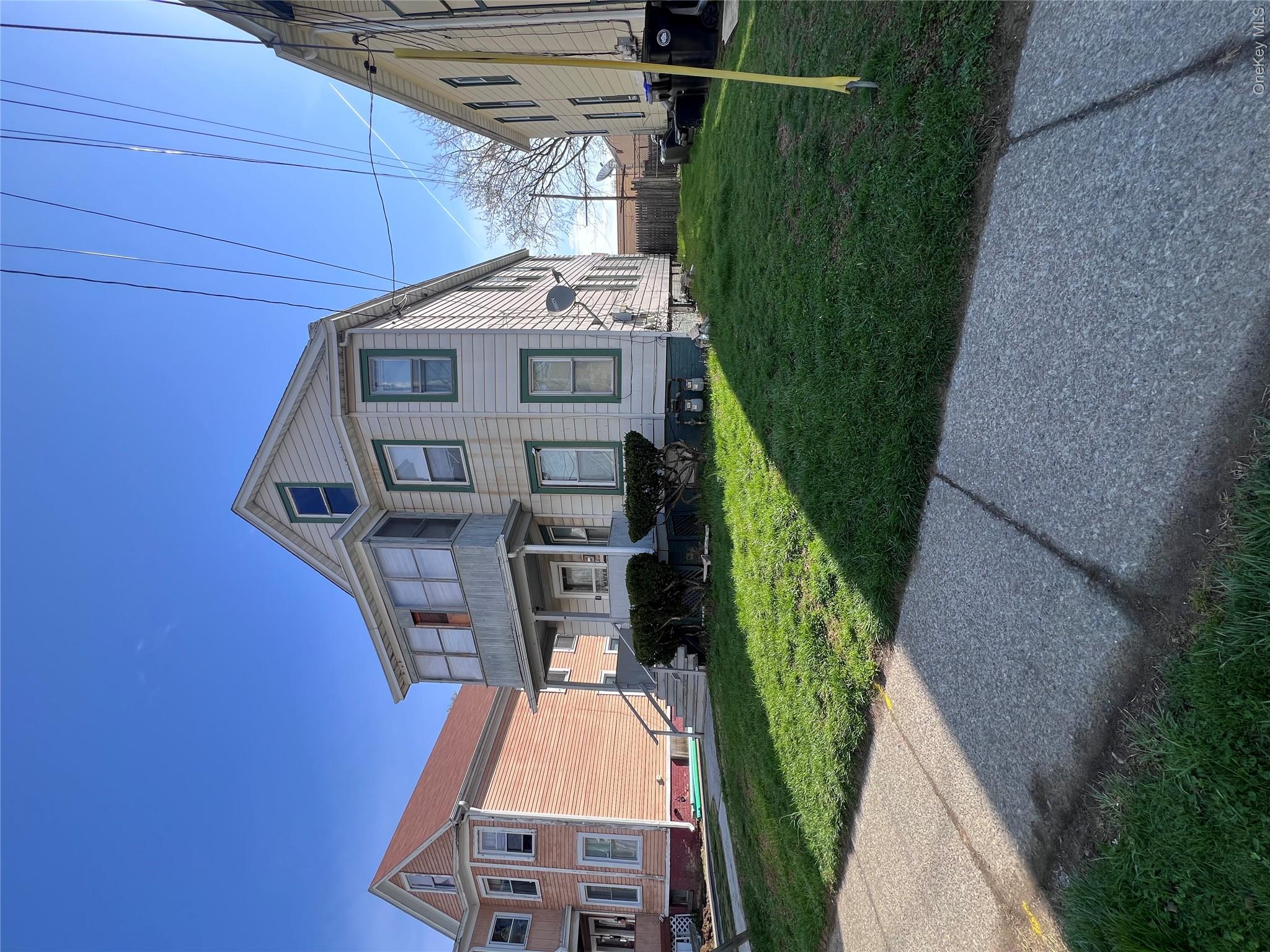 12 May Street Poughkeepsie, NY 12603 - Photo 1 of 17 a front view of a house with a yard and trees