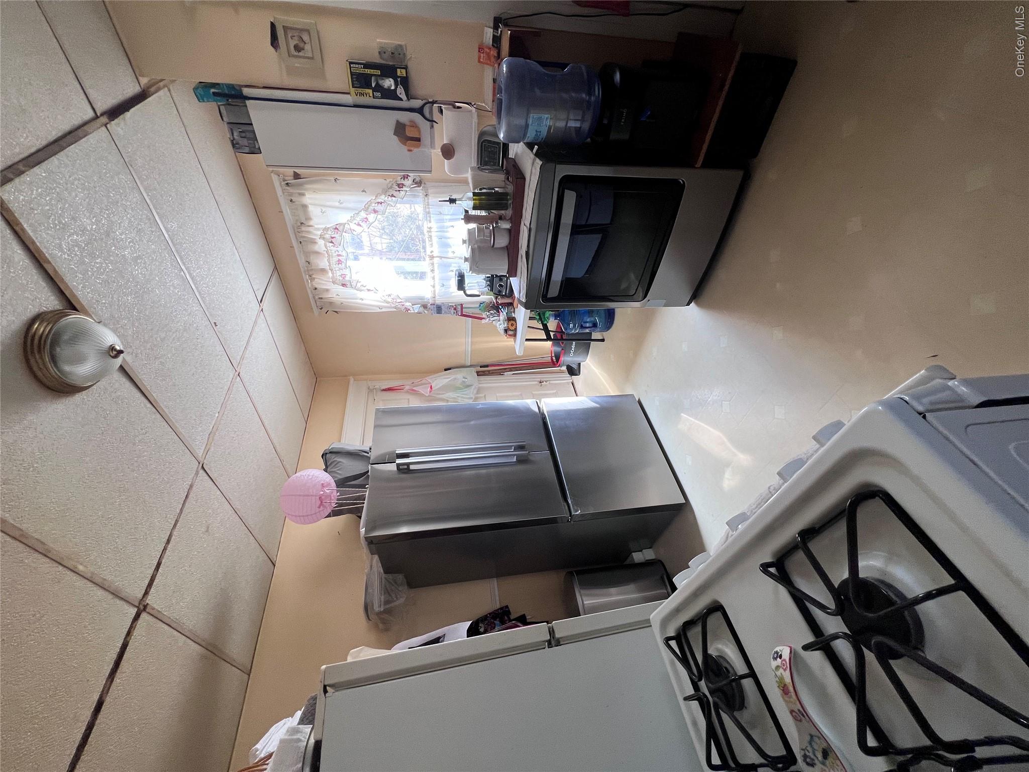 12 May Street Poughkeepsie, NY 12603 - Photo 2 of 17 a kitchen with a stove and a refrigerator