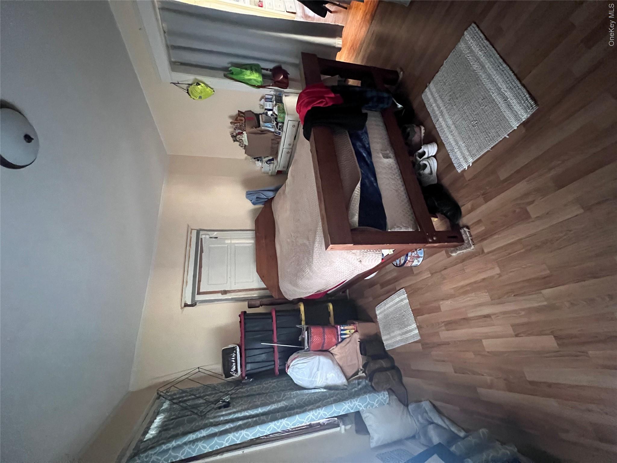 12 May Street Poughkeepsie, NY 12603 - Photo 5 of 17 a bedroom with a bed and wooden floor