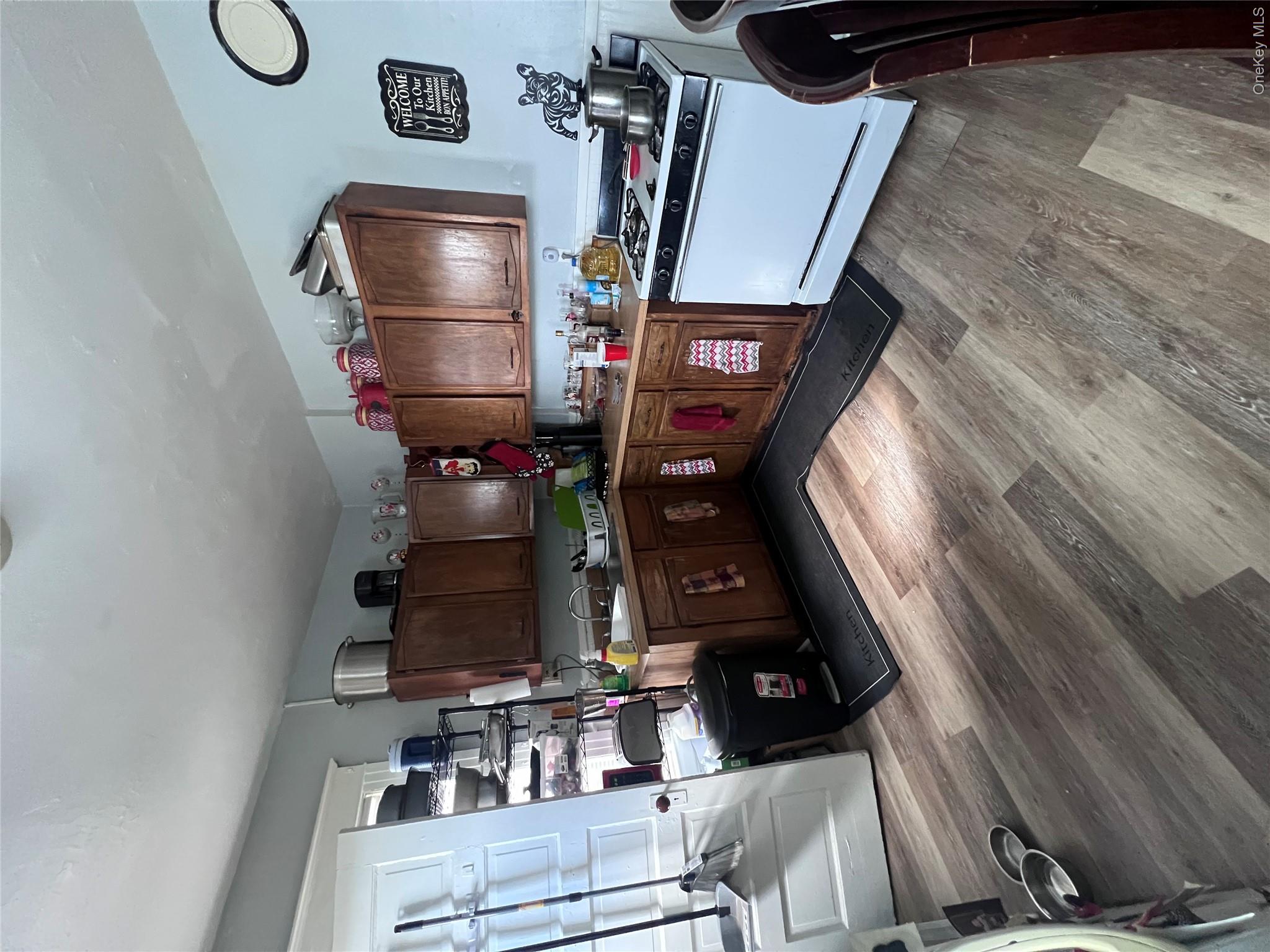 12 May Street Poughkeepsie, NY 12603 - Photo 10 of 17 a kitchen with wooden cabinets and a sink