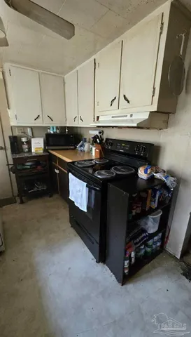 a kitchen with a stove and a cabinet