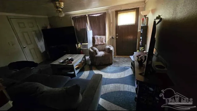 a living room with furniture and a flat screen tv