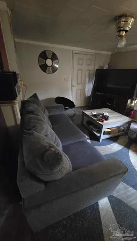 a living room with furniture and a lamp