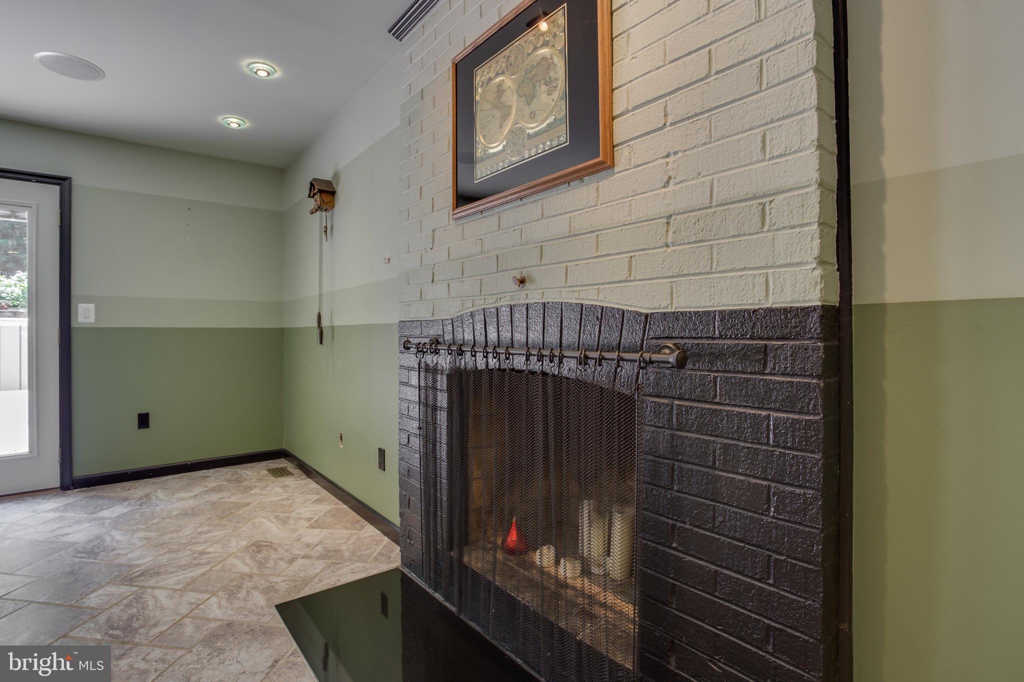 18520 Cabin Road Triangle, VA 22172 - Photo 16 of 39 Warm family room with brick wood burning fireplace