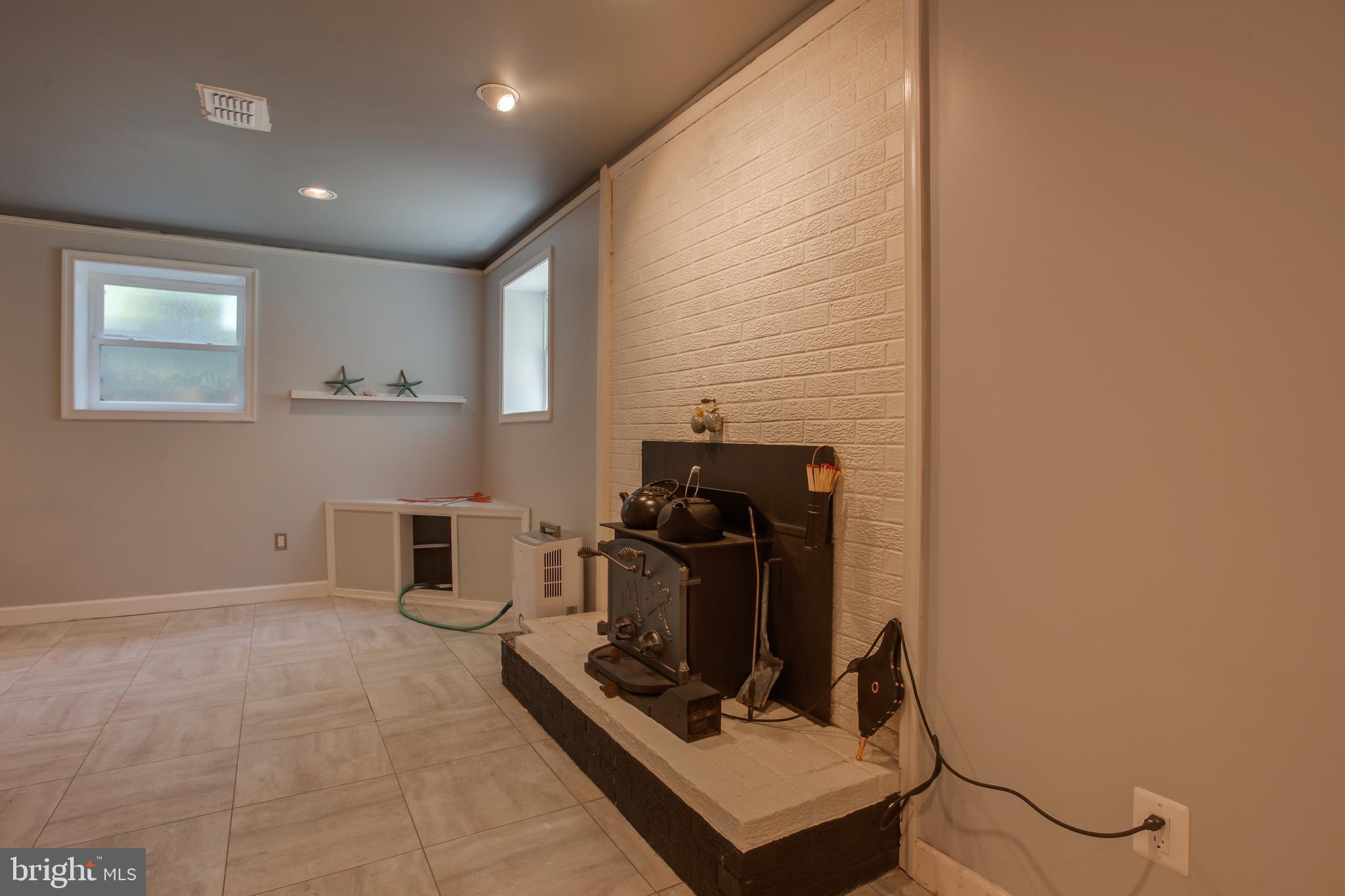 18520 Cabin Road Triangle, VA 22172 - Photo 21 of 39 Basement features a timeless wood burning stove.
