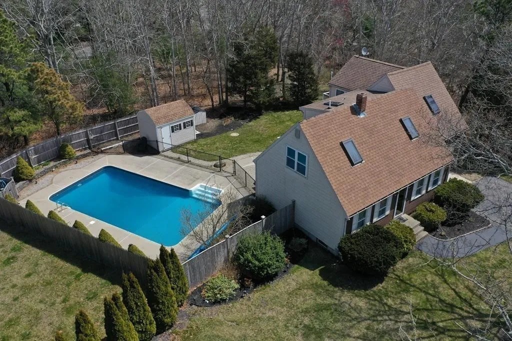 an aerial view of a house with yard and patio