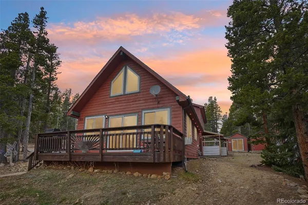 a view of a house with a yard and deck