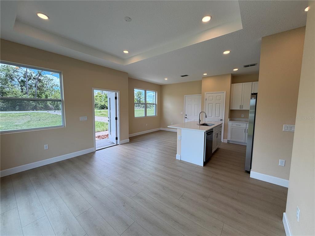 4661 Hickory Tree Road St. Cloud, FL 34772 - Photo 10 of 20 an open space with kitchen view and wooden floor