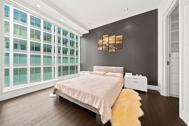 a bedroom with a bed and a large window