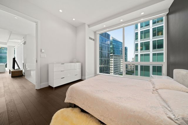 a bedroom with furniture and a large window