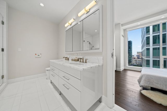 a bathroom with a sink double vanity and a mirror