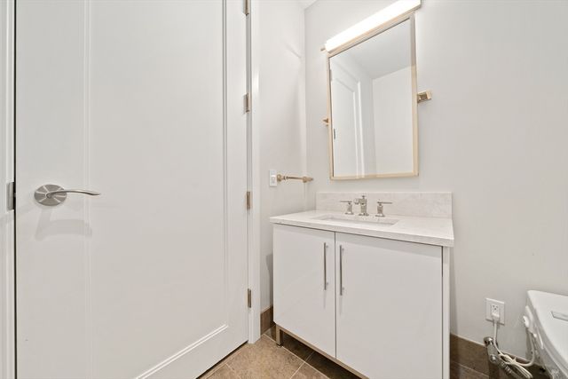 a bathroom with a sink a mirror and vanity