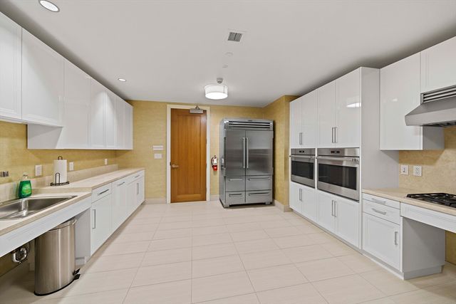 a view of a roof deck with dining table and chairs