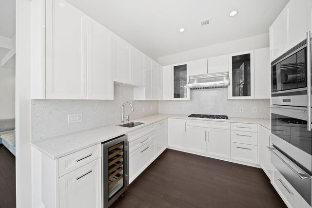 a kitchen with stainless steel appliances granite countertop a stove and a sink