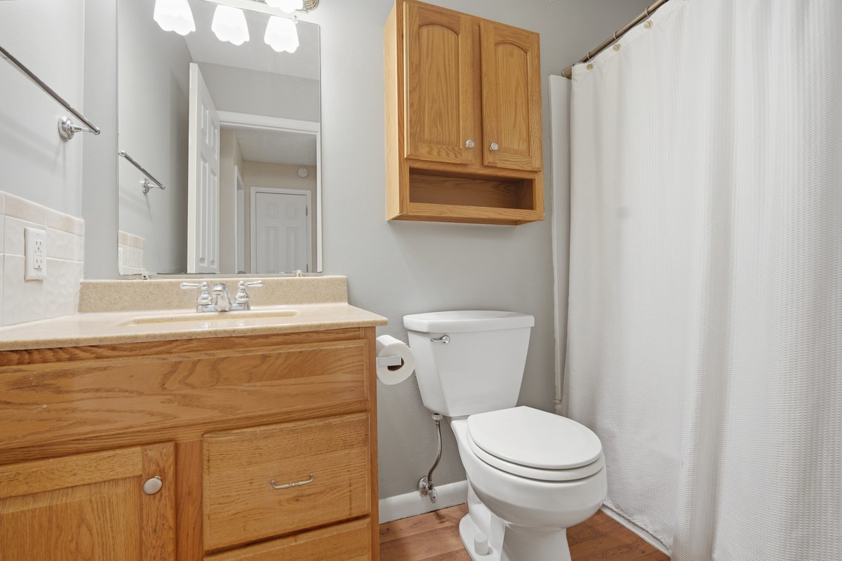 1532 Hunt Drive, Unit A Normal, IL 61761 - Photo 17 of 25 a bathroom with a toilet sink and mirror