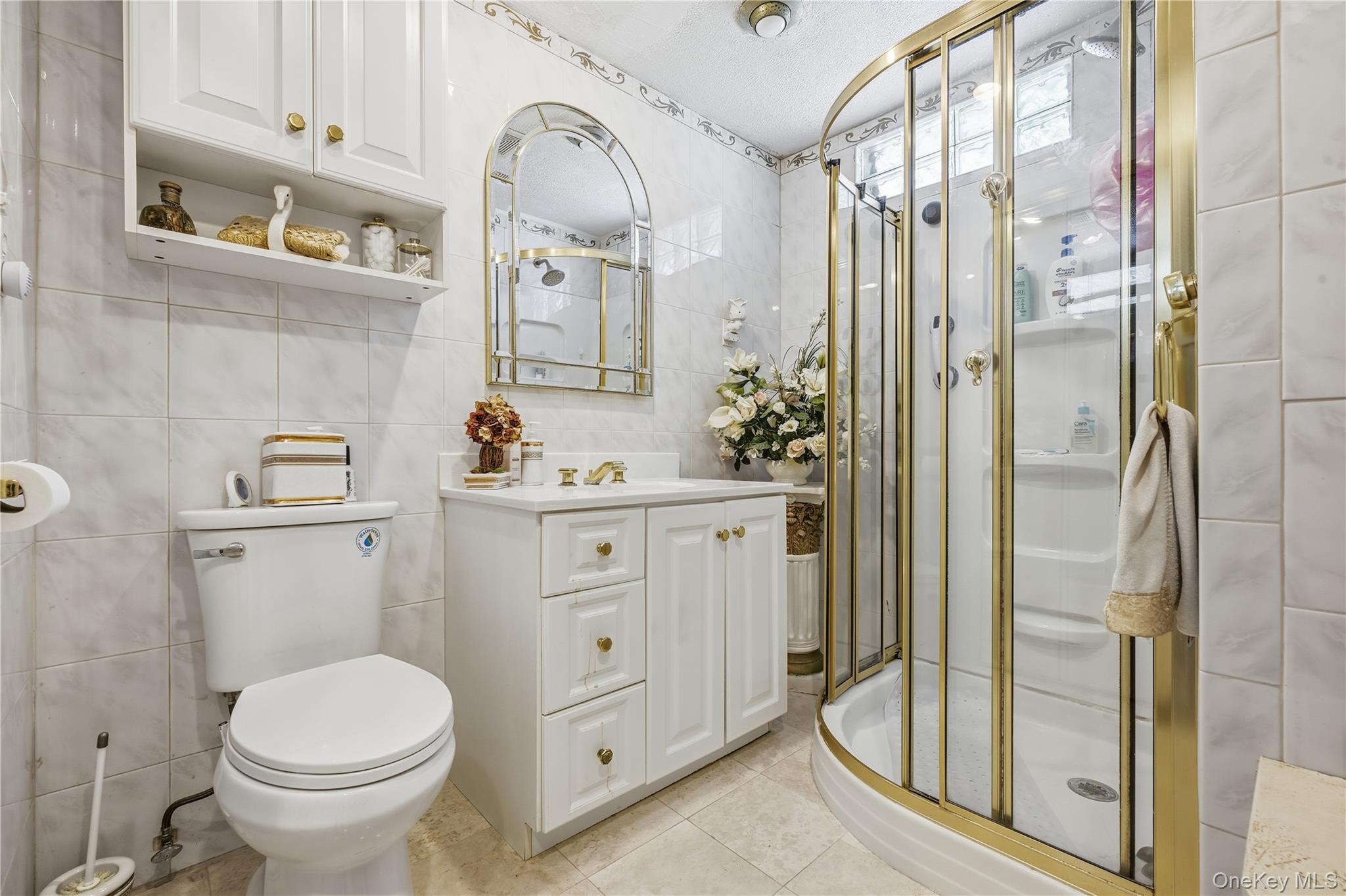 89-18 239th Street Queens, NY 11426 - Photo 6 of 14 a bathroom with a sink toilet and shower