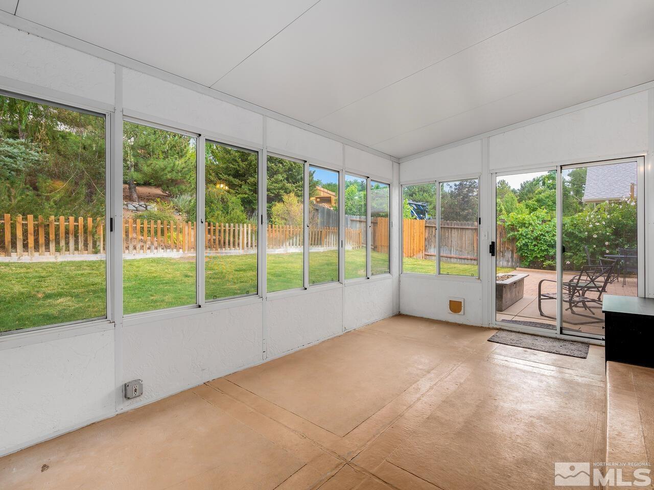 1722 Rainbow Ridge Road Reno, NV 89523 - Photo 13 of 27 a view of an empty room with wooden floor and a floor to ceiling window
