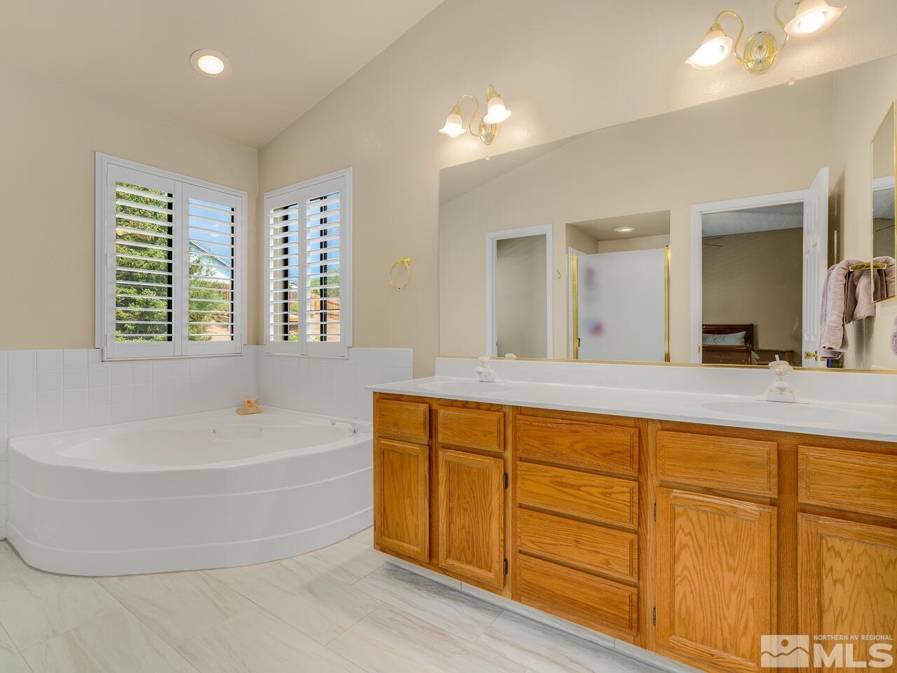 1722 Rainbow Ridge Road Reno, NV 89523 - Photo 20 of 27 a bathroom with a tub a sink and a large window