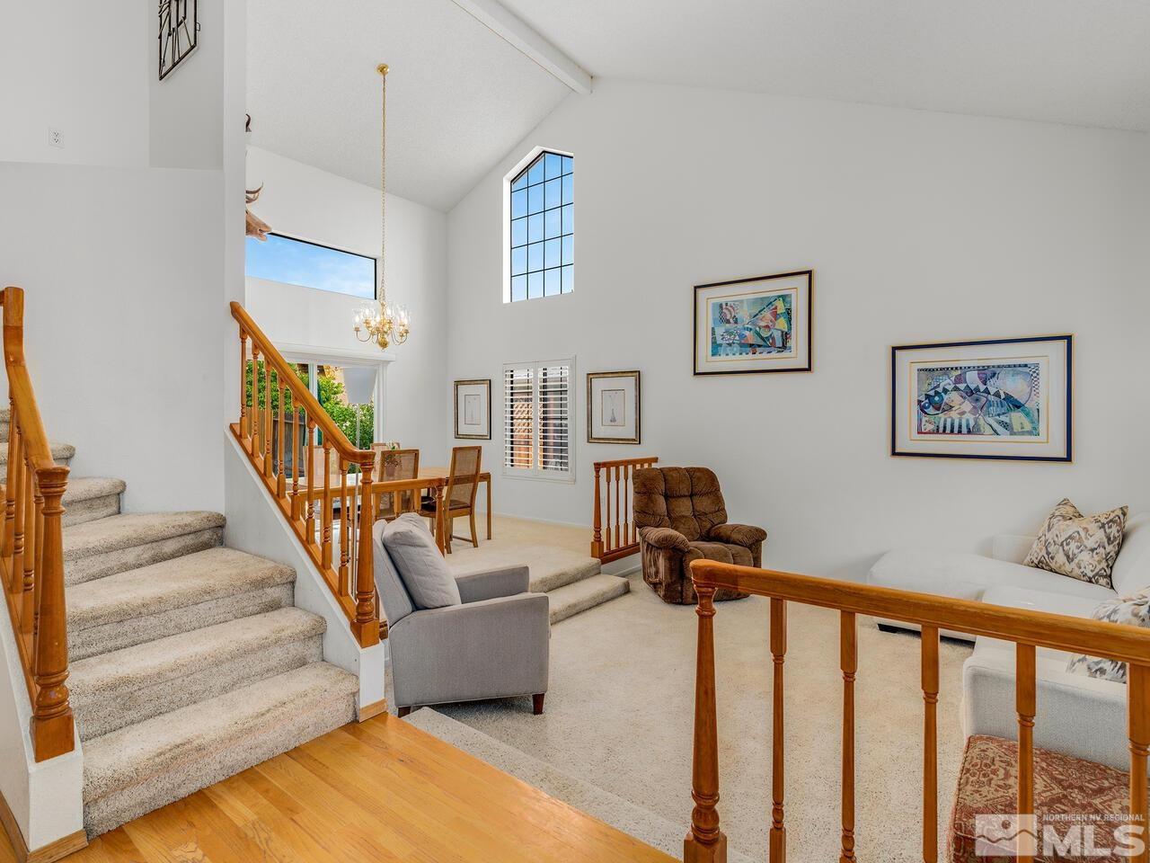 1722 Rainbow Ridge Road Reno, NV 89523 - Photo 2 of 27 a living room with furniture or stairs and a chandelier
