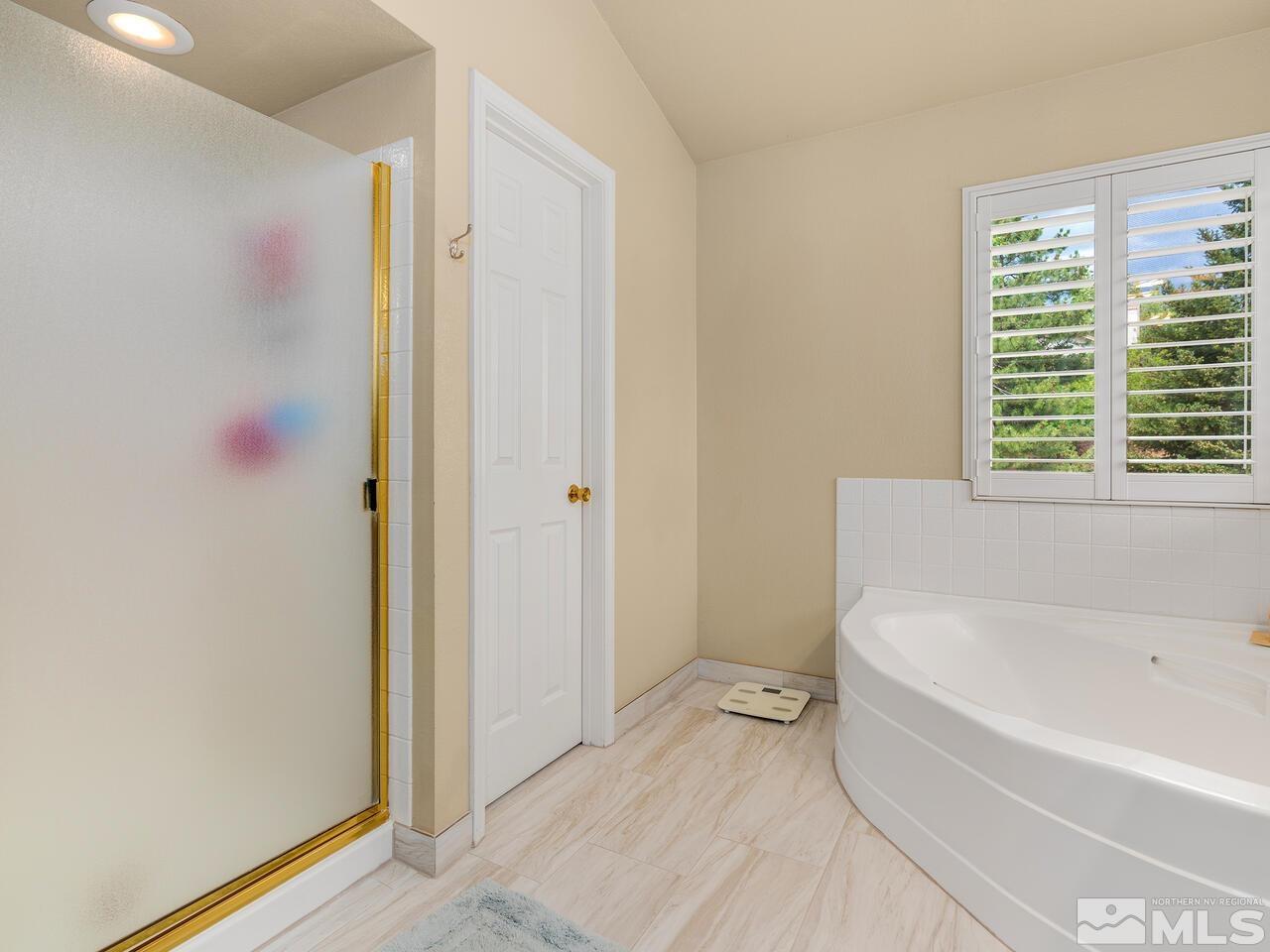 1722 Rainbow Ridge Road Reno, NV 89523 - Photo 21 of 27 a white bath tub sitting next to a toilet