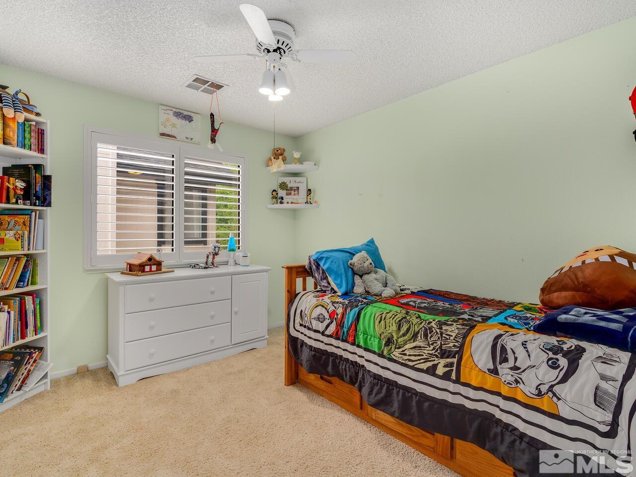 1722 Rainbow Ridge Road Reno, NV 89523 - Photo 22 of 27 a bedroom with furniture and a book shelf