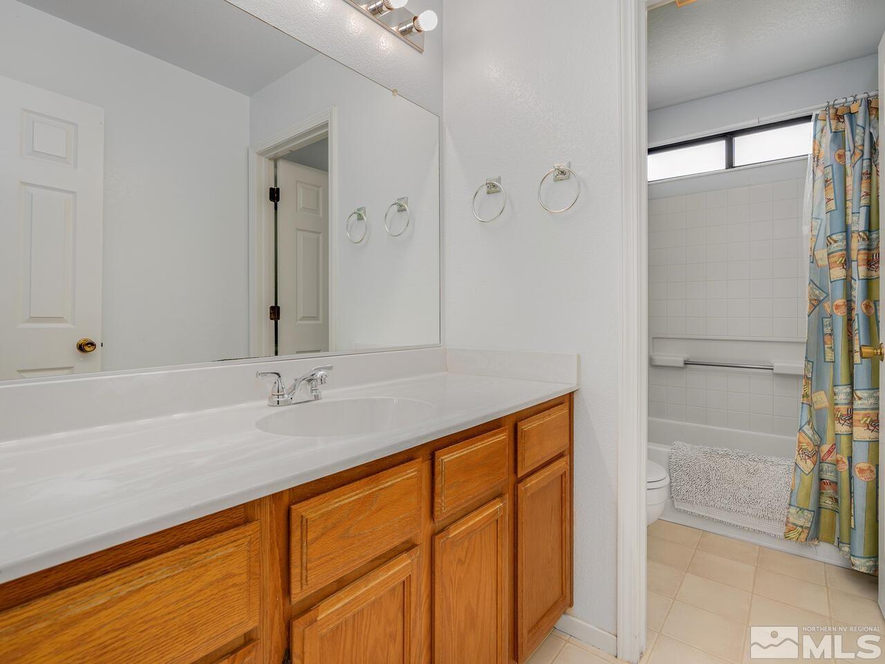 1722 Rainbow Ridge Road Reno, NV 89523 - Photo 25 of 27 a bathroom with a granite countertop sink and mirror