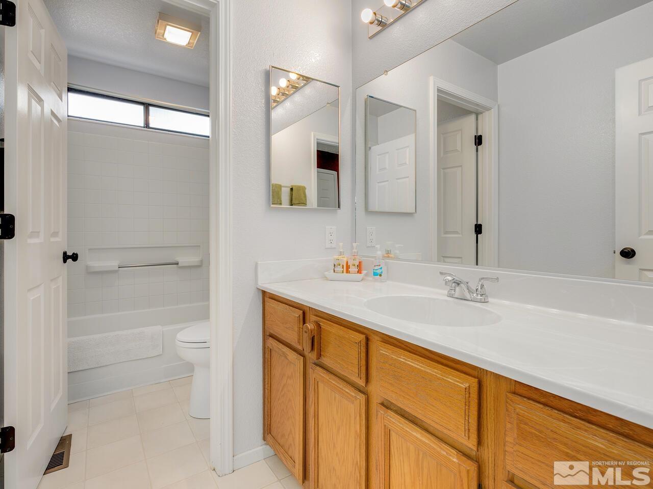 1722 Rainbow Ridge Road Reno, NV 89523 - Photo 26 of 27 a bathroom with a sink a toilet and shower