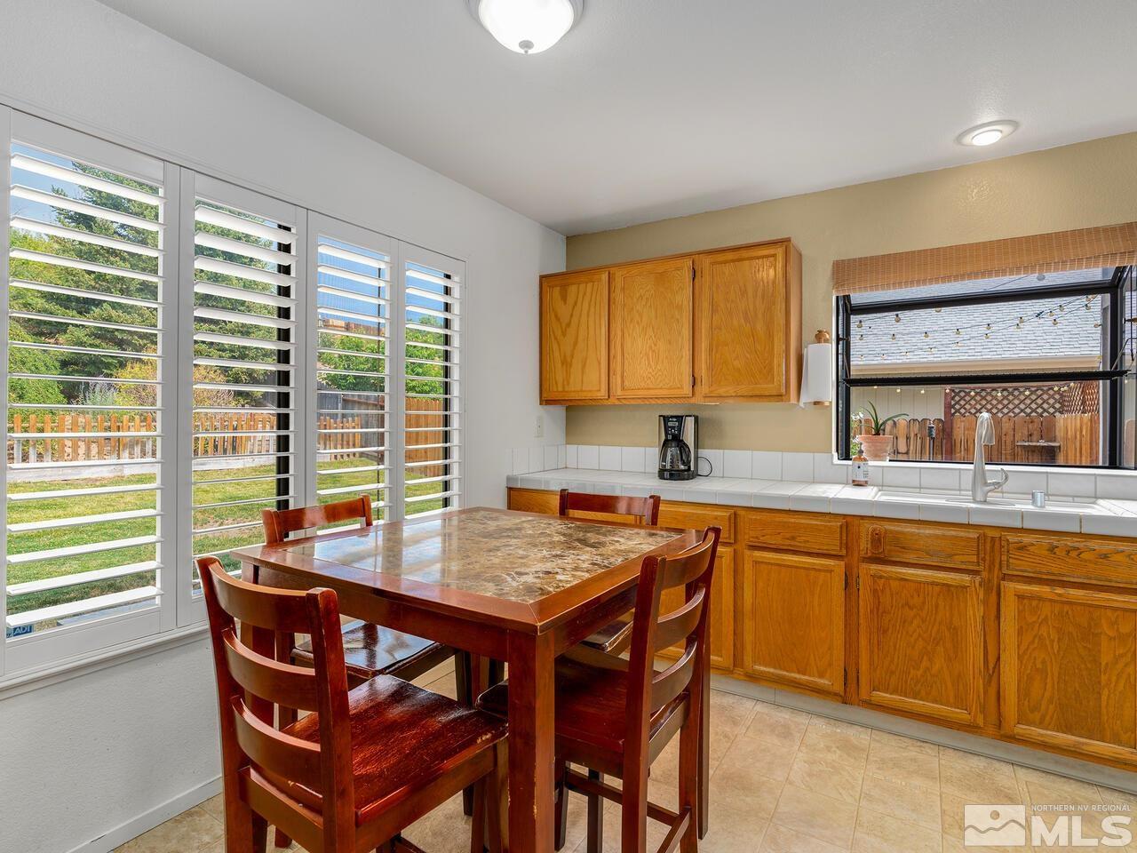 1722 Rainbow Ridge Road Reno, NV 89523 - Photo 9 of 27 a kitchen with a wooden table and chairs
