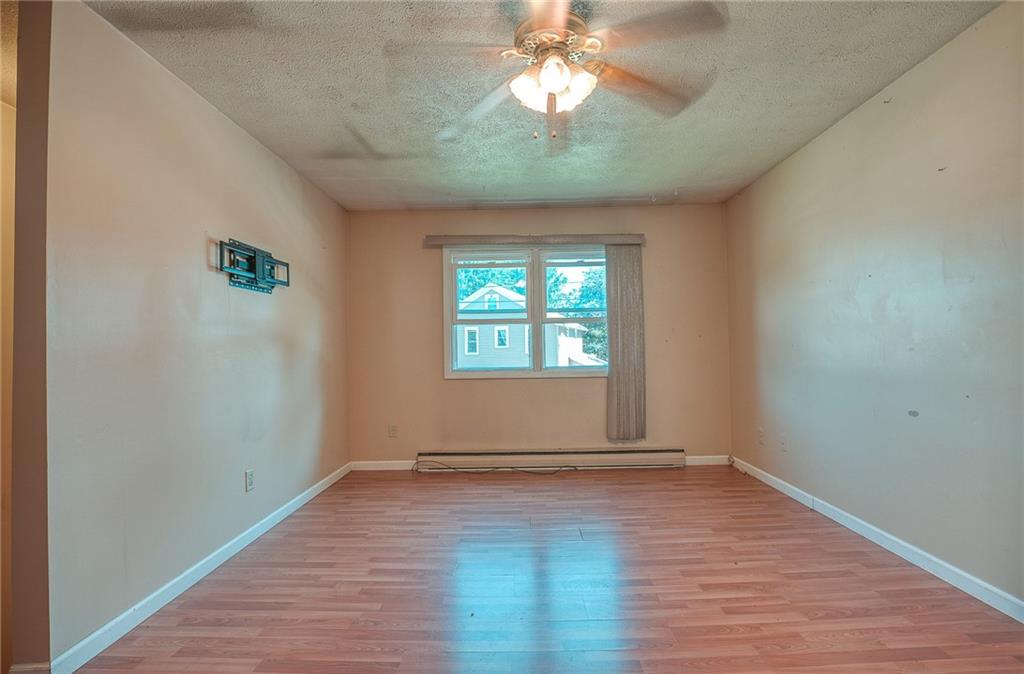 296 East Pike Road Indiana, PA 15701 - Photo 2 of 46 an empty room with wooden floor chandelier fan and windows