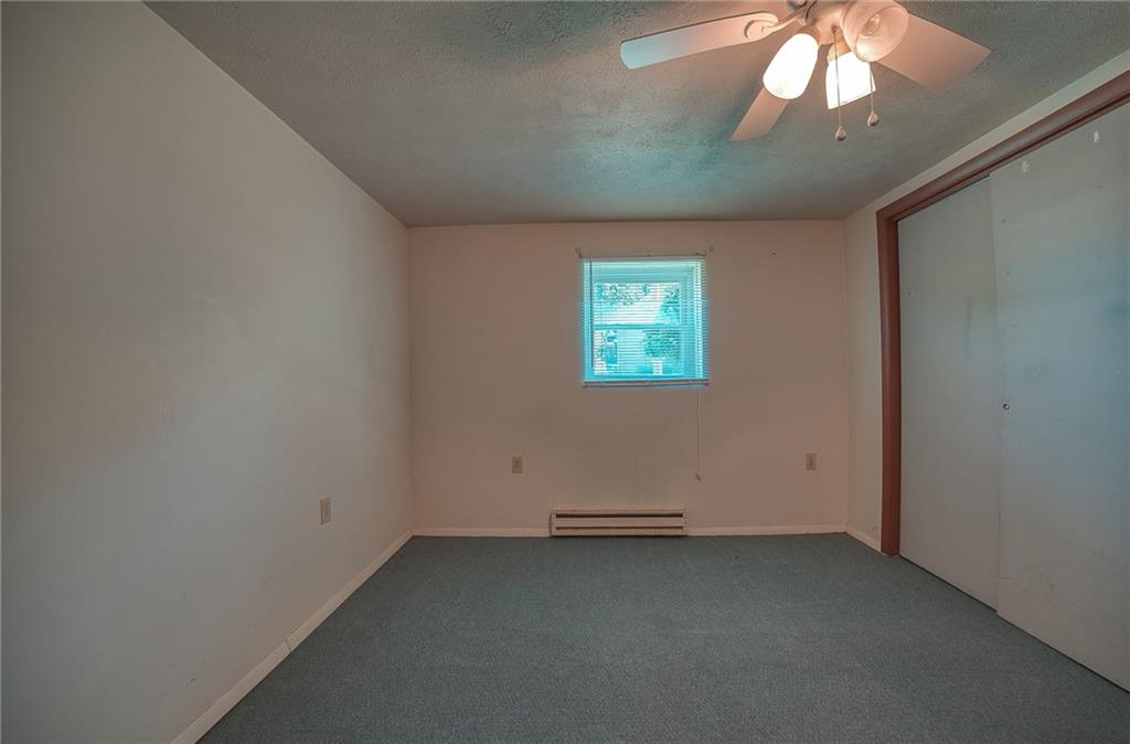 296 East Pike Road Indiana, PA 15701 - Photo 29 of 46 an empty room with a chandelier fan and windows