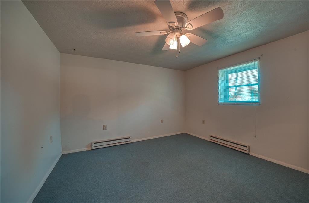 296 East Pike Road Indiana, PA 15701 - Photo 30 of 46 an empty room with a chandelier fan and windows