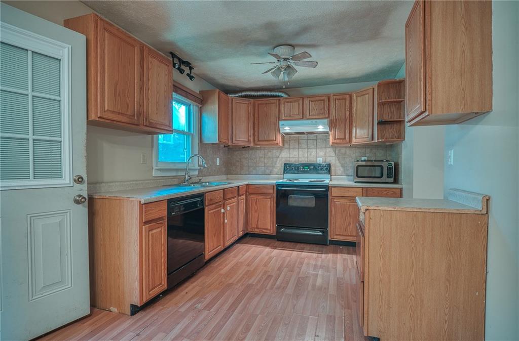 296 East Pike Road Indiana, PA 15701 - Photo 5 of 46 a kitchen with stainless steel appliances granite countertop wooden cabinets a sink a stove a refrigerator and island